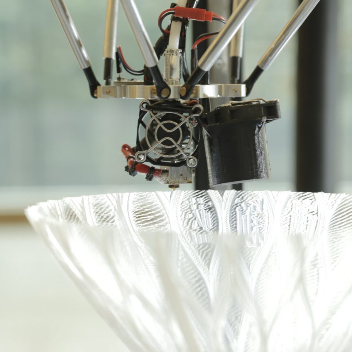 Close-Up on the Delta Tower 3D Printer and the component being printed with Chinese Characters